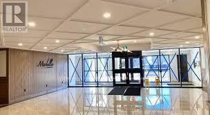 A room with a wooden wall and a glass partition.
