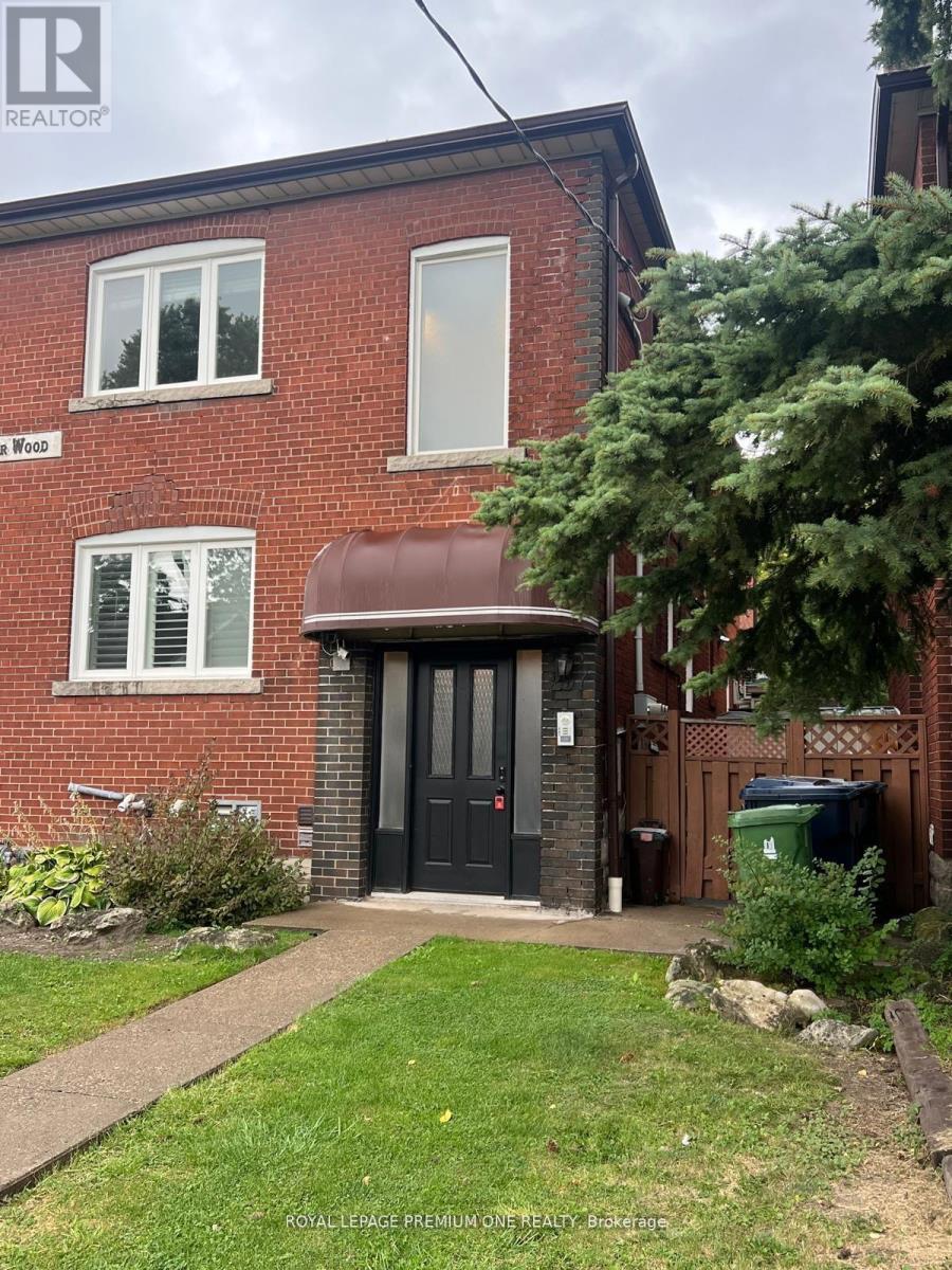 A red brick house with a black door and windows.