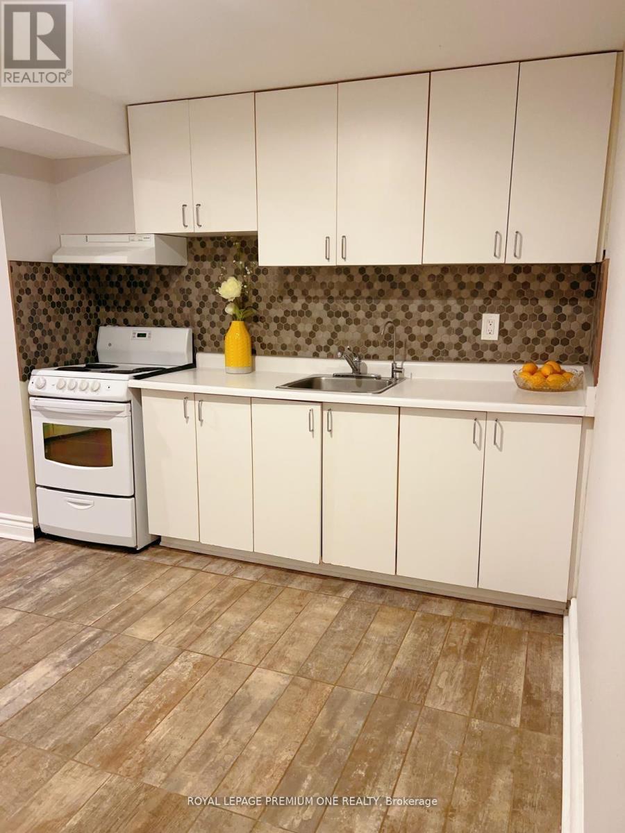 A kitchen with white cabinets and a tiled backsplash.
