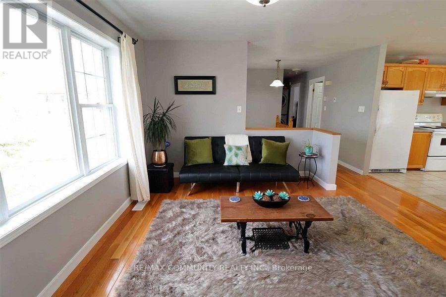 A living room with a black couch and a coffee table.