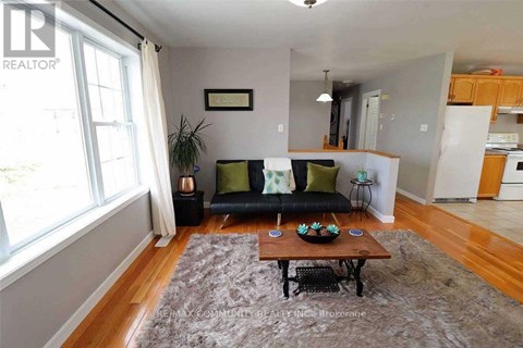 A living room with a black couch and a coffee table.