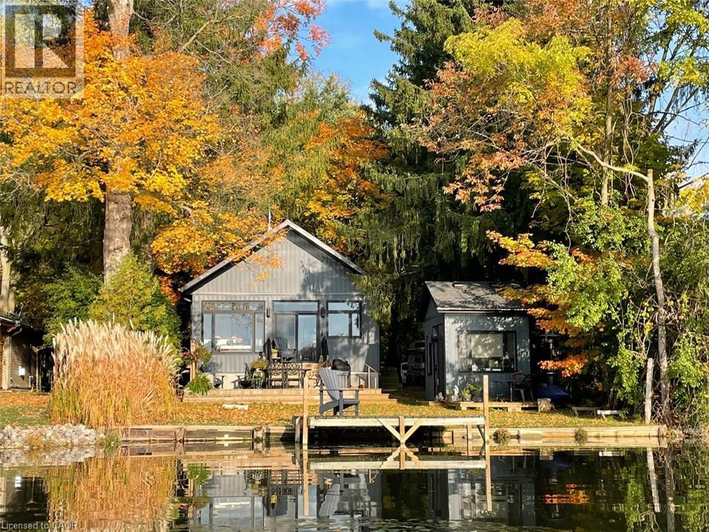 A house is surrounded by trees with autumn leaves.
