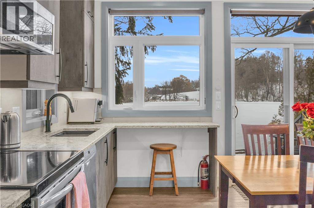 A kitchen with a stove top oven and a window.
