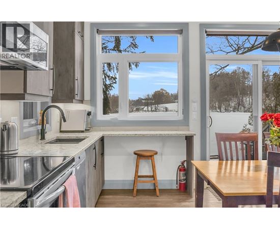 A kitchen with a stove top oven and a window.