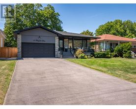 A house with a garage and a driveway in front of it.