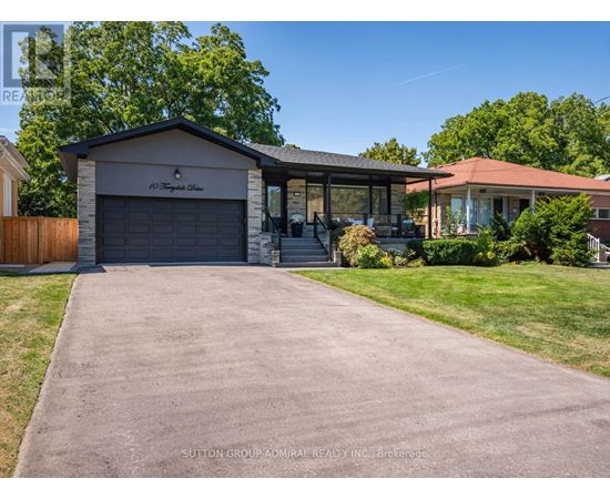 A house with a garage and a driveway in front of it.
