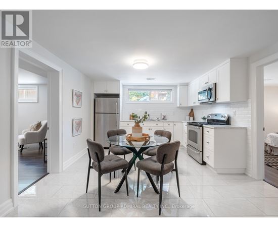 A modern kitchen with a dining table set for four.