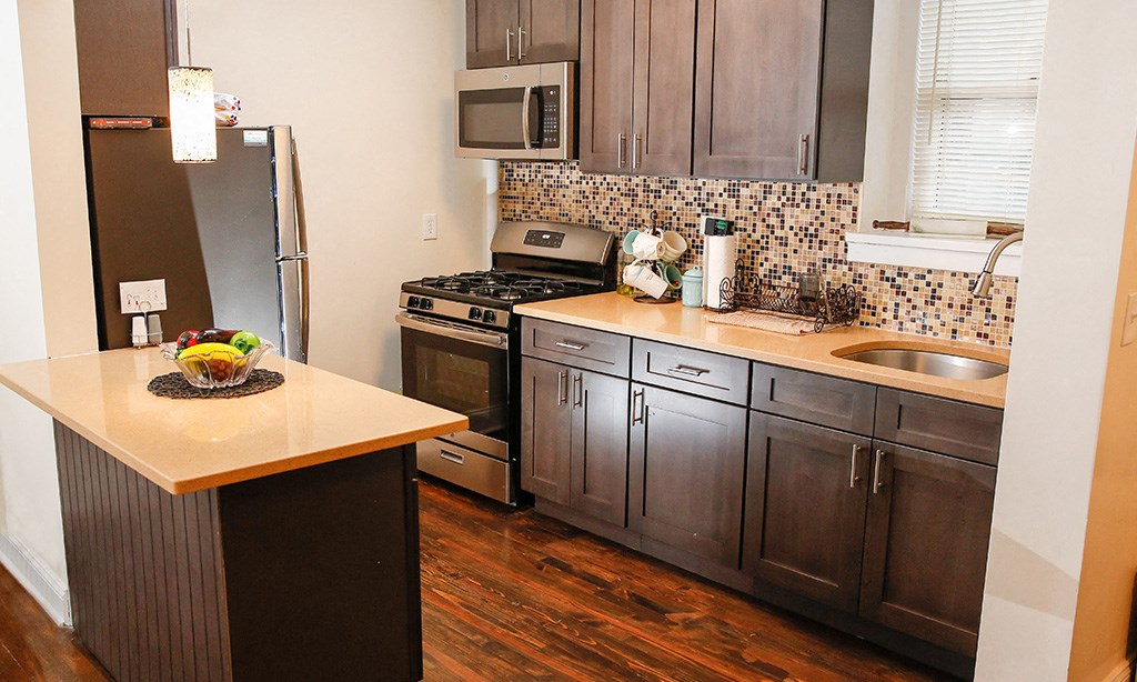 a kitchen with wooden cabinets and stainless steel appliances