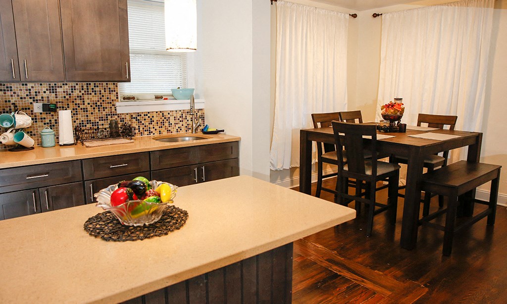a kitchen and dining room with a table and chairs