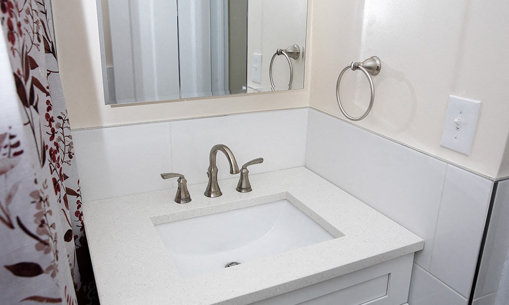 a small bathroom with a sink and a mirror