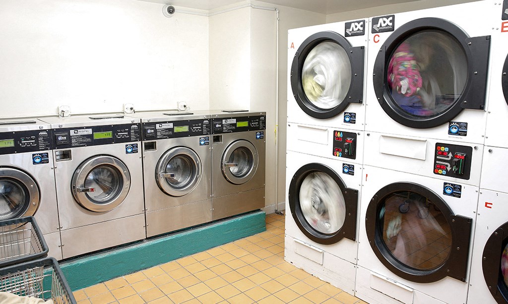 a row of washing machines in a laundry room