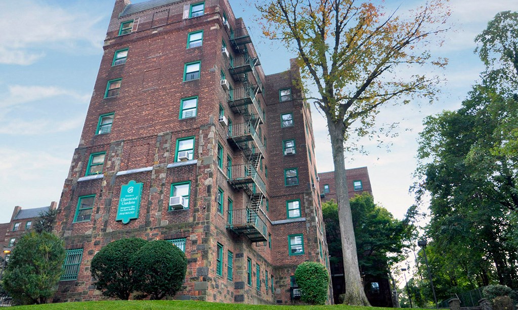 a tall red brick apartment building with balconies