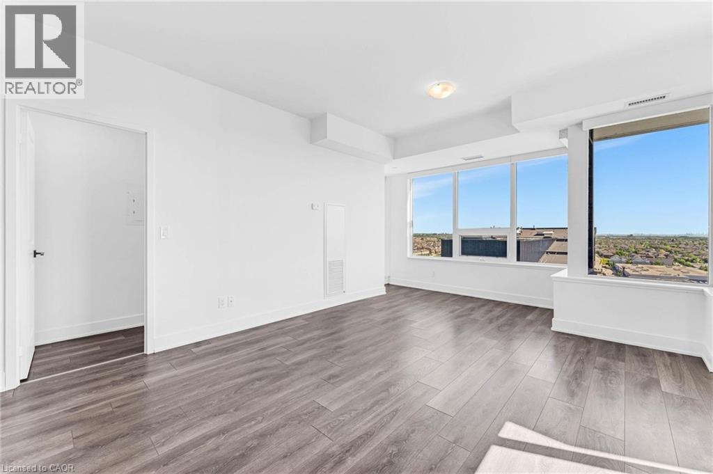 A spacious room with a large window overlooking a landscape.