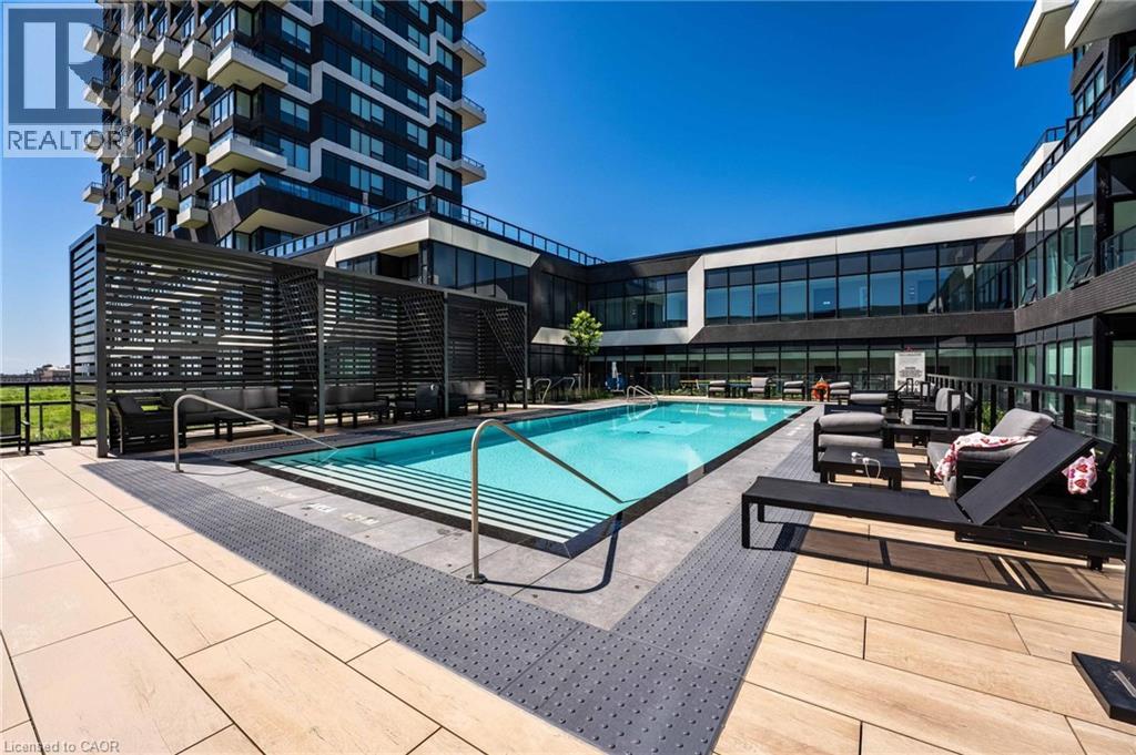 A modern building with a pool in front.