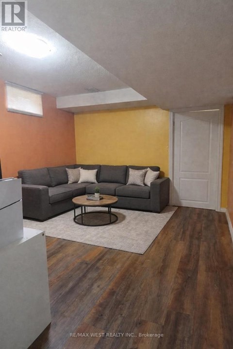 A living room with a grey couch and a coffee table.