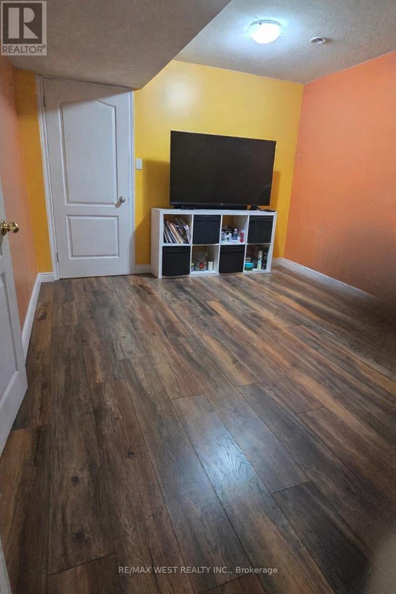 A room with a wooden floor and a white door.