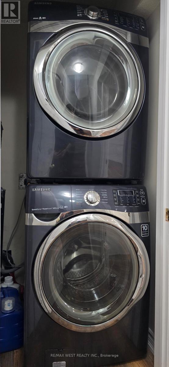 A black front loading washing machine with a transparent door.