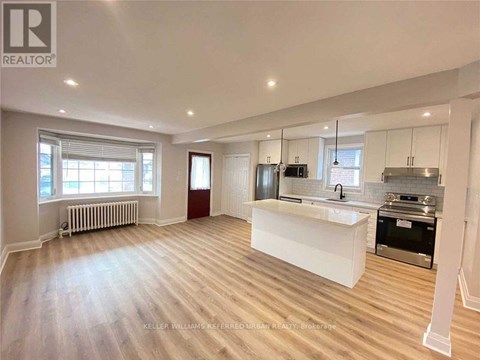 A spacious kitchen with a white countertop and stainless steel appliances.