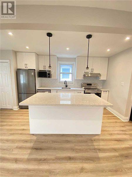 A modern kitchen with a large island in the middle.