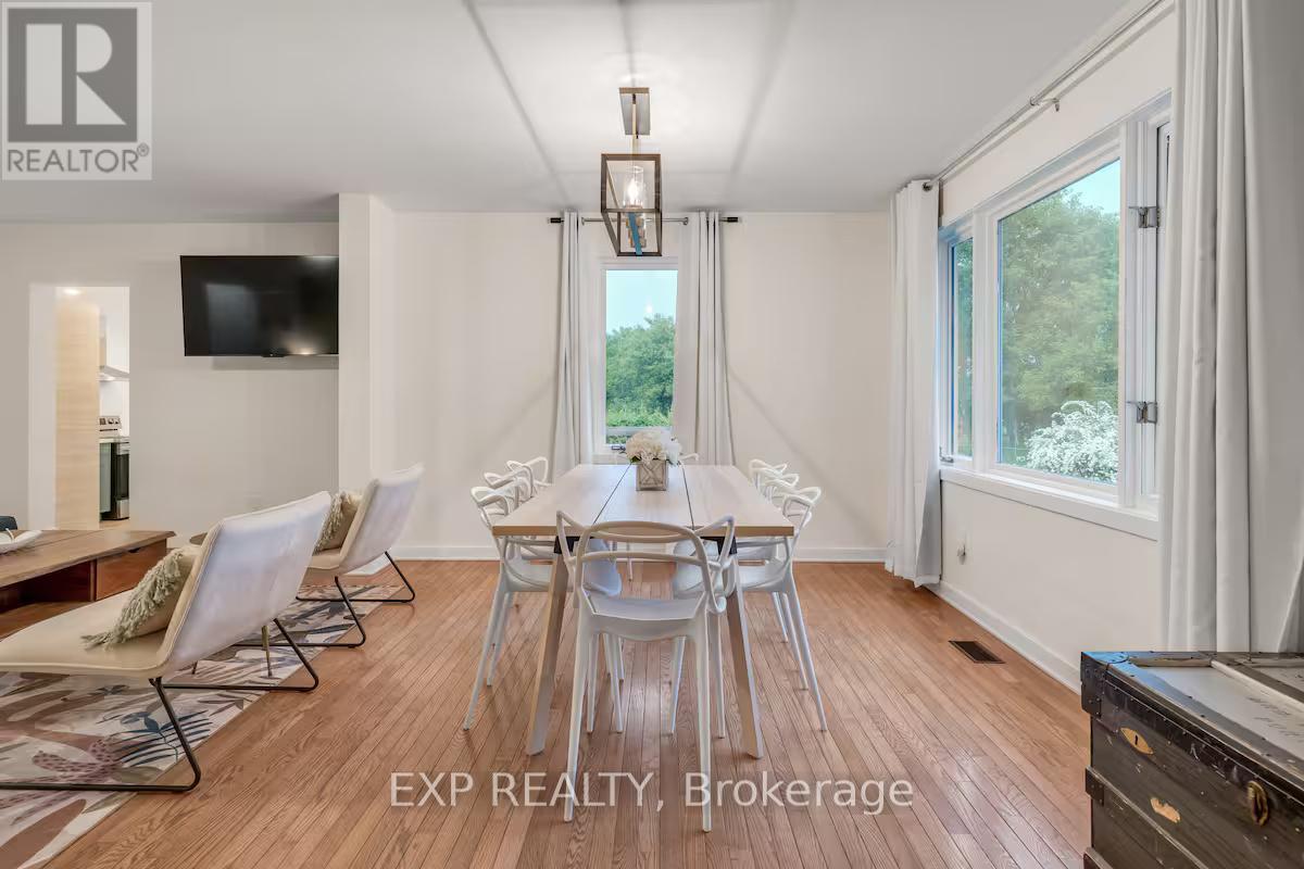 A dining room with a wooden table and chairs.