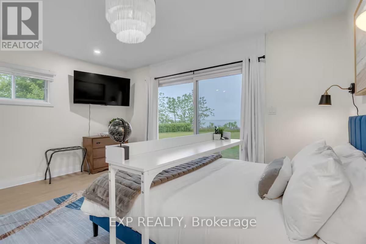 A bedroom with a large bed and a flat screen TV mounted on the wall.
