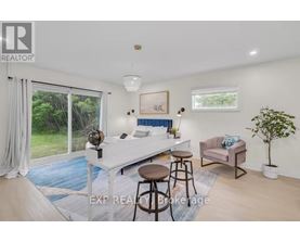 A bedroom with a bed, a couch, and a chair in it.