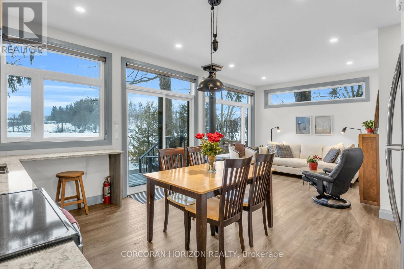 A dining room with a table set for six with a view of the outdoors.