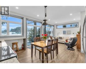 A dining room with a table set for six with a view of the outdoors.