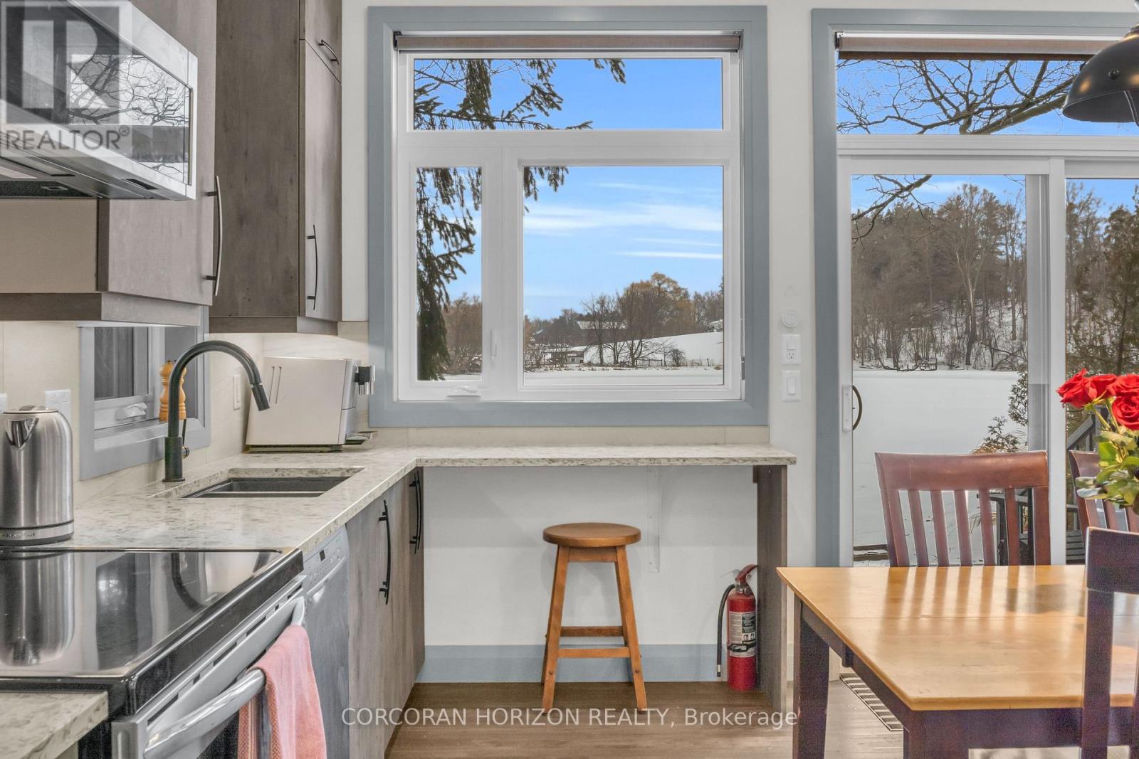 A kitchen with a stove top oven and a window.
