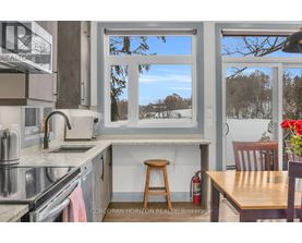 A kitchen with a stove top oven and a window.
