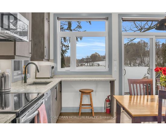 A kitchen with a stove top oven and a window.