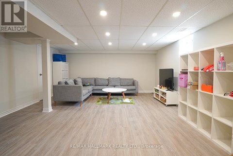 A spacious living room with a grey sofa and a coffee table.