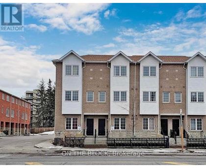 A row of townhouses with a sign that says "REALTOR" on the top left corner.