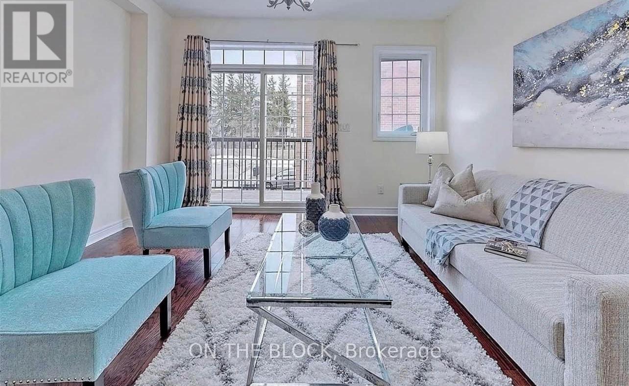A living room with a blue chair and a white couch.