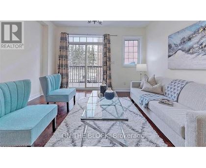 A living room with a blue chair and a white couch.