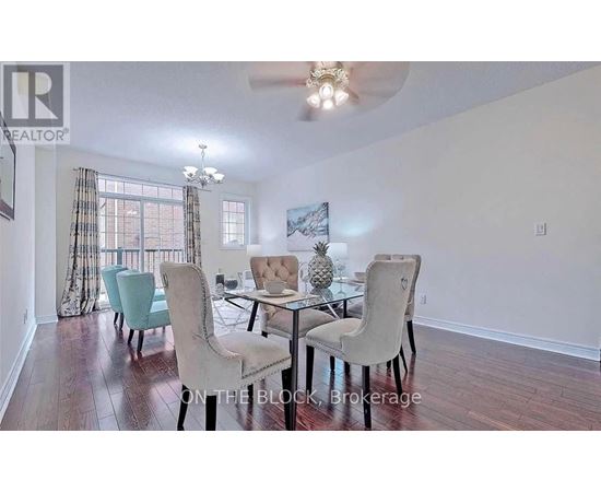 A dining room with a glass table and chairs.