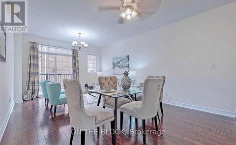 A dining room with a glass table and chairs.