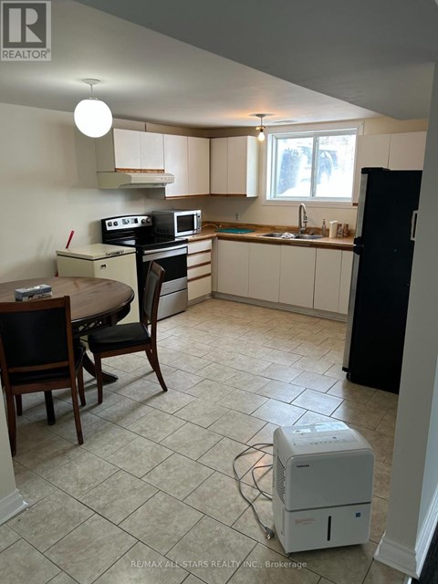 A kitchen with a table and chairs.