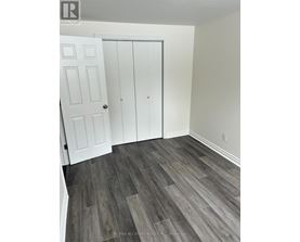 A room with a white door and a white cabinet.