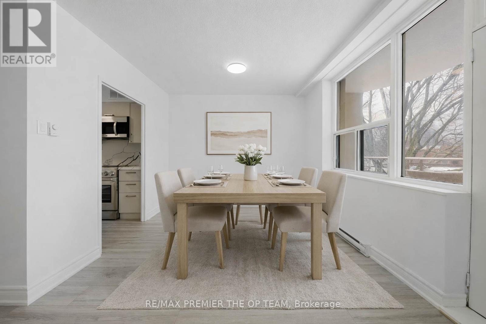 A dining room with a table set for four.