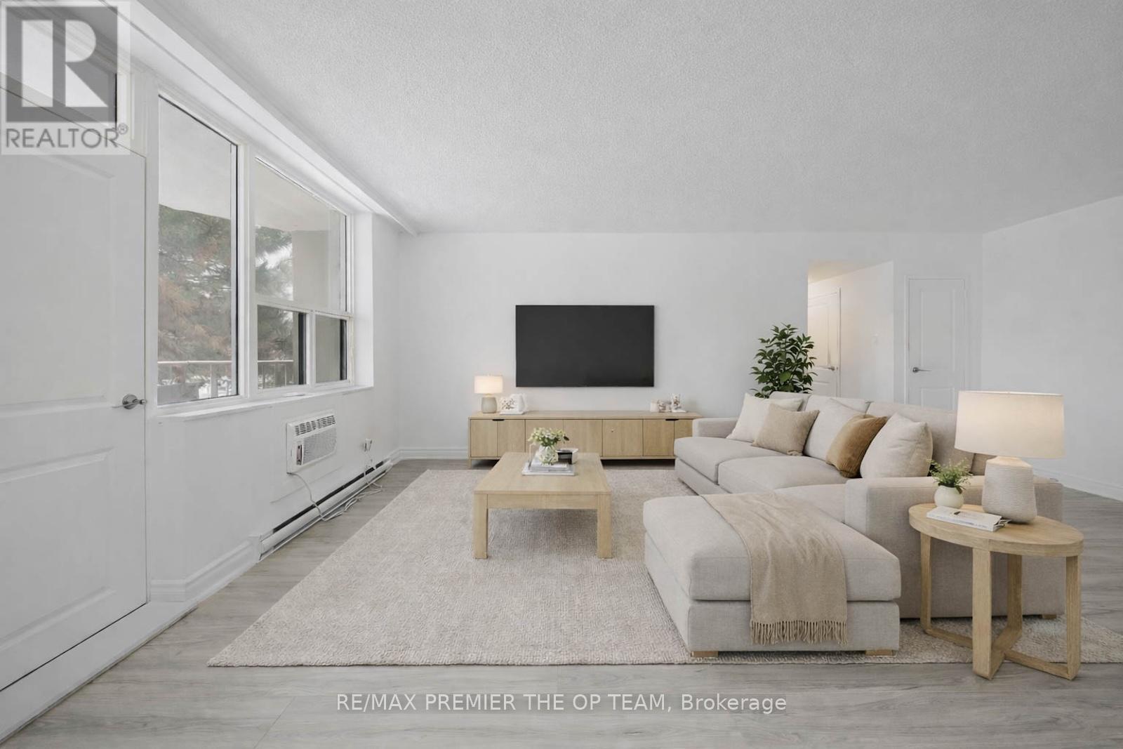A living room with a couch, a coffee table, and a television.