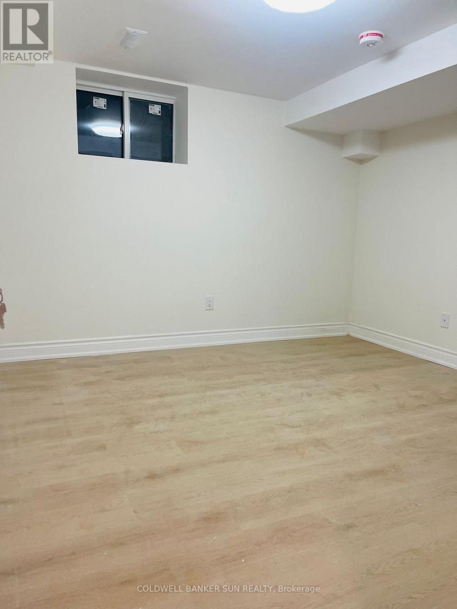 A room with a window and wooden flooring.