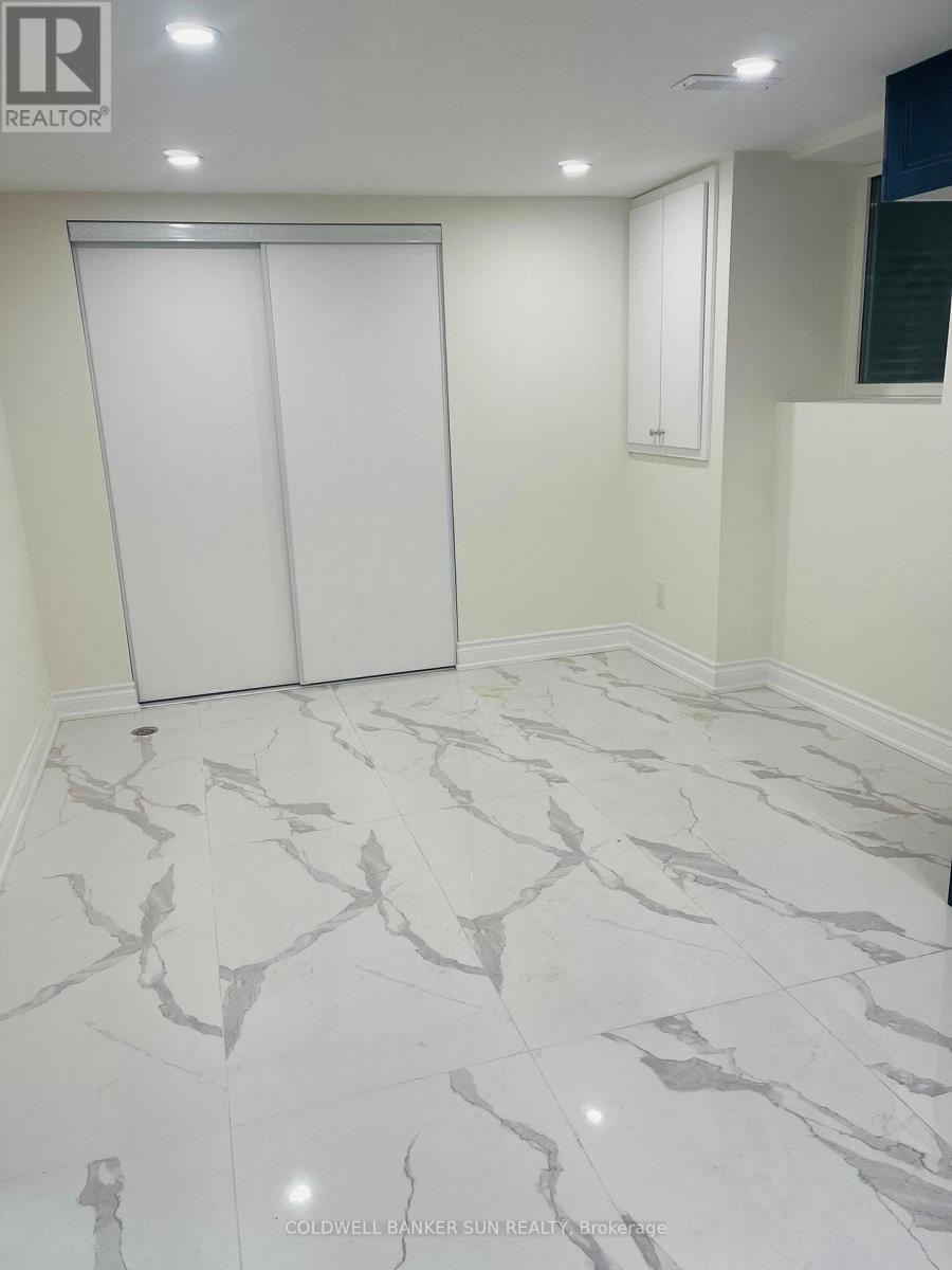 A room with a marble floor and white walls.
