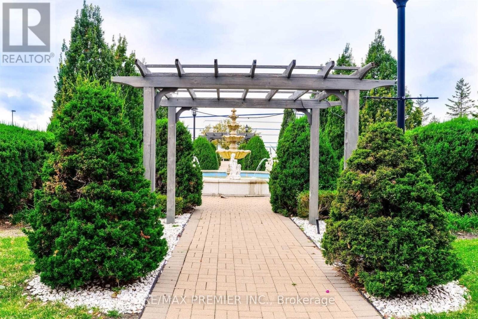 A garden with a walkway and a gazebo.