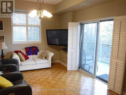 A living room with a white couch and a flat screen TV.