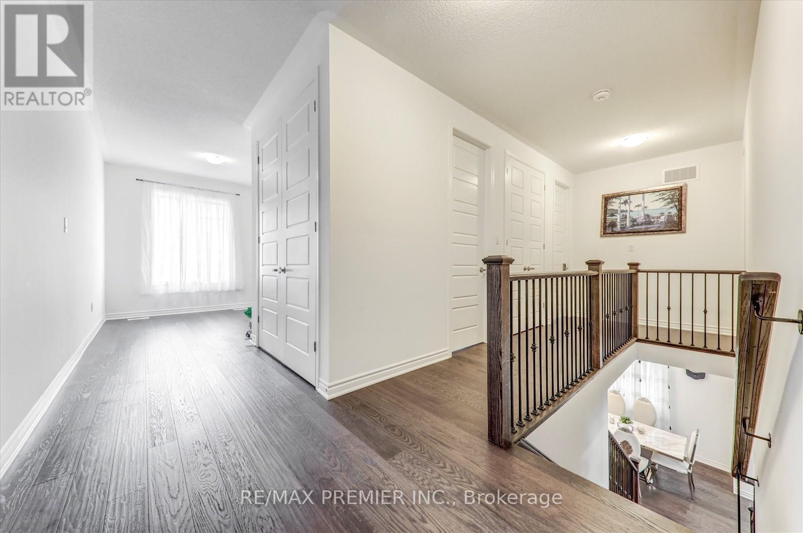 A spacious room with a staircase leading to the upper floor.