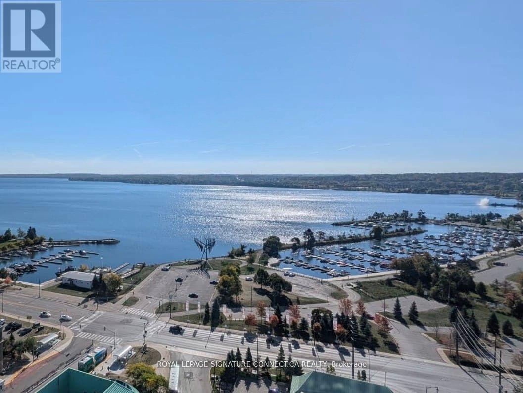 A real estate company logo is displayed on an aerial view of a waterfront property.