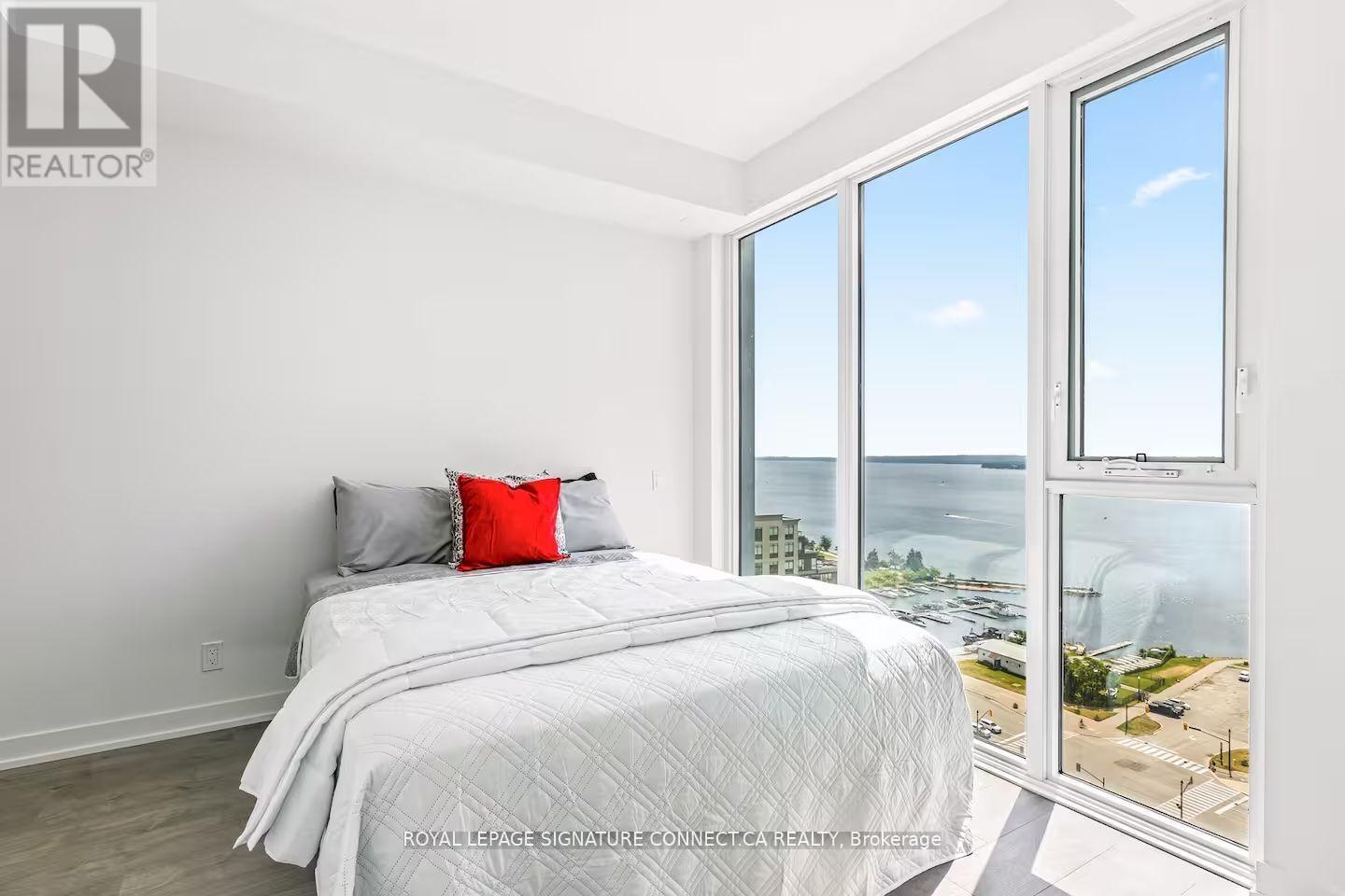 A bedroom with a large bed and a view of the city.
