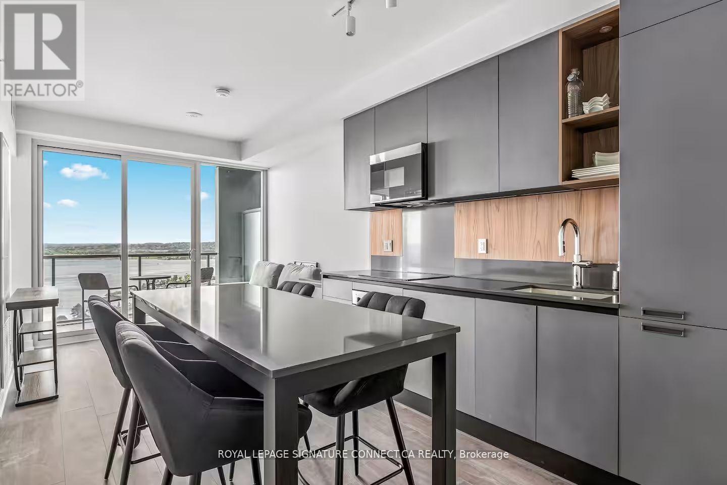 A modern kitchen with a dining table and chairs.