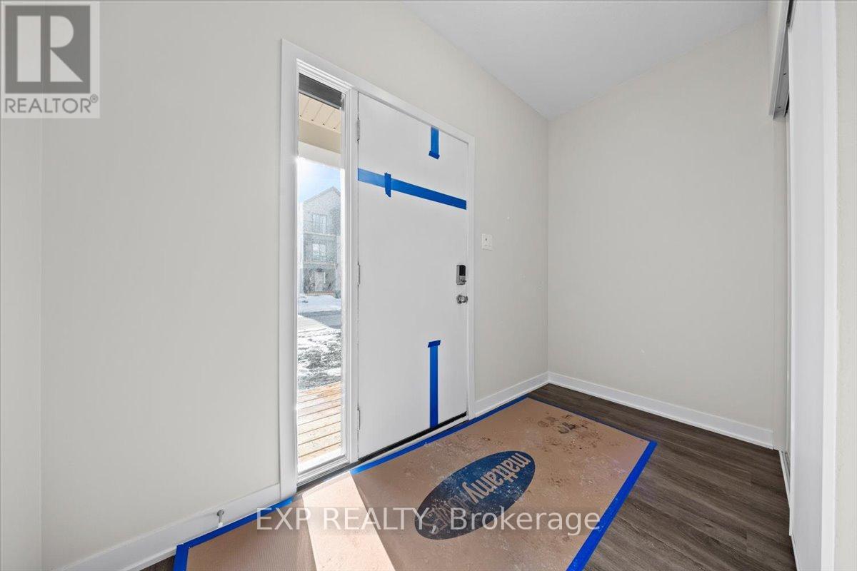 A room with a door and a window, with the words EXP REALTY Brokerage written on the floor.